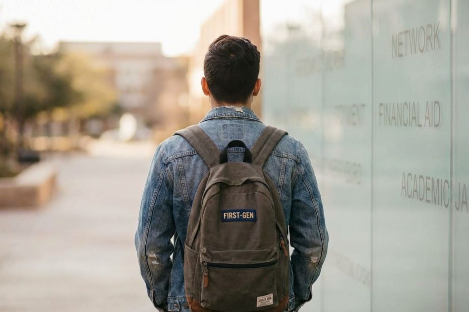First-generation student sitting alone on campus steps, looking thoughtful while navigating academic pressure and belonging